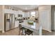 Modern kitchen with stainless steel appliances and an island at 847 Ledge St, Lochbuie, CO 80603