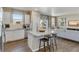 Kitchen with island, stainless steel appliances, and view to living room at 847 Ledge St, Lochbuie, CO 80603
