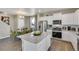 Open concept kitchen with island and stainless steel appliances at 847 Ledge St, Lochbuie, CO 80603