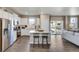 Open concept kitchen features stainless steel appliances and island at 847 Ledge St, Lochbuie, CO 80603
