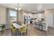 Modern kitchen with white cabinets, stainless steel appliances, and island at 847 Ledge St, Lochbuie, CO 80603