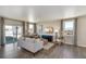 Living room with hardwood floors, comfy seating, and sliding glass doors at 847 Ledge St, Lochbuie, CO 80603