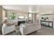 Spacious living room with gray sofas, large windows, and hardwood floors at 847 Ledge St, Lochbuie, CO 80603