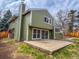 The backyard features a well-kept lawn, sliding glass doors, patio, and lush surrounding trees at 6640 S Heritage W Pl, Centennial, CO 80111