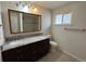 Updated bathroom with a dual sink vanity, a large mirror and stylish fixtures at 6640 S Heritage W Pl, Centennial, CO 80111