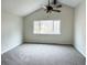Bright bedroom featuring vaulted ceilings, a modern ceiling fan, and a large window at 6640 S Heritage W Pl, Centennial, CO 80111