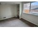 Bedroom with built-in shelving and a large window overlooking the neighborhood at 6640 S Heritage W Pl, Centennial, CO 80111