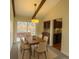 Dining room featuring an exposed beam ceiling, and access to the kitchen and a covered patio at 6640 S Heritage W Pl, Centennial, CO 80111