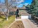 Aerial view of a charming two-story home with an attached garage and lush surrounding landscape at 6640 S Heritage W Pl, Centennial, CO 80111