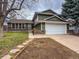 Charming two-story home featuring an attached two car garage and manicured lawn and garden at 6640 S Heritage W Pl, Centennial, CO 80111