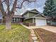 Charming two-story home featuring an attached two car garage and manicured lawn and garden at 6640 S Heritage W Pl, Centennial, CO 80111