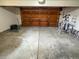 Spacious two car garage with concrete floor and wooden overhead door at 6640 S Heritage W Pl, Centennial, CO 80111