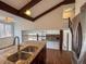 Open concept kitchen with granite counters, stainless steel appliances, and a view of the living spaces at 6640 S Heritage W Pl, Centennial, CO 80111