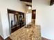 Kitchen with granite counters, stainless steel appliances, and access to other living spaces at 6640 S Heritage W Pl, Centennial, CO 80111