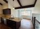 Kitchen with granite countertops, stainless steel sink, dark wood cabinets, and large window overlooking the backyard at 6640 S Heritage W Pl, Centennial, CO 80111