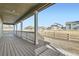 Cozy back porch showcasing wooden decking, white railings, and serene views at 17632 Datura St, Broomfield, CO 80023