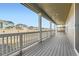 Expansive back porch with wooden decking, white railings, and peaceful neighborhood views at 17632 Datura St, Broomfield, CO 80023