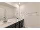 Bathroom featuring double vanity with modern fixtures, a large mirror, and neutral walls at 17632 Datura St, Broomfield, CO 80023