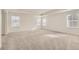 Bedroom featuring tray ceiling, carpet and great natural light from three windows at 17632 Datura St, Broomfield, CO 80023