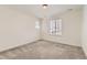 Bright bedroom featuring neutral walls, plush carpeting, and natural light streaming through window at 17632 Datura St, Broomfield, CO 80023