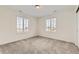 Bright bedroom featuring neutral walls, plush carpeting, and natural light streaming through two windows at 17632 Datura St, Broomfield, CO 80023