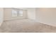 Spacious bedroom featuring neutral walls, plush carpet, and large windows offering abundant natural light at 17632 Datura St, Broomfield, CO 80023