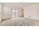 Light-filled bedroom features neutral walls, carpet and a sliding door at 17632 Datura St, Broomfield, CO 80023