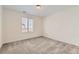 Well-lit bedroom with neutral walls, comfortable carpeting, and a large window at 17632 Datura St, Broomfield, CO 80023