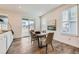 Dining room with a table and chairs, sliding glass doors leading to the outside, and a modern light fixture at 17632 Datura St, Broomfield, CO 80023