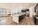 Spacious kitchen with dark cabinets, stainless steel appliances, a large island and an open floor plan at 17632 Datura St, Broomfield, CO 80023