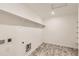 Neat laundry room with shelving, modern flooring, and hookups for washer and dryer at 17632 Datura St, Broomfield, CO 80023