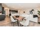 Bright and modern open-concept living space with a dining area and an open view to the kitchen at 17632 Datura St, Broomfield, CO 80023