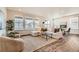 Cozy living room featuring a plush sectional sofa, large windows, and modern décor at 17632 Datura St, Broomfield, CO 80023