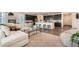 Stylish living room with an open floor plan, flows to the kitchen, with sleek countertops and bar stool seating at 17632 Datura St, Broomfield, CO 80023