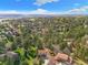 An aerial view of a home surrounded by lush greenery and tall trees in a suburban neighborhood at 8409 Lightening View Dr, Parker, CO 80134