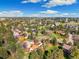 Aerial view showcasing neighborhood homes nestled amongst lush trees and greenery under a sunny sky at 8409 Lightening View Dr, Parker, CO 80134
