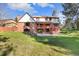 Back exterior showcasing a deck, stairs, sliding glass doors, and a yard at 8409 Lightening View Dr, Parker, CO 80134