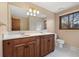 Bathroom featuring double sink vanity with granite countertop and bright lighting at 8409 Lightening View Dr, Parker, CO 80134