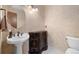 Stylish powder room with elegant vanity, patterned walls, and white pedestal sink at 8409 Lightening View Dr, Parker, CO 80134