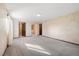 Large bedroom with neutral carpet and multiple doors to ensuite bathroom and closets at 8409 Lightening View Dr, Parker, CO 80134