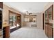 Dining area featuring white tile floors, exposed brick, and access to the back deck at 8409 Lightening View Dr, Parker, CO 80134