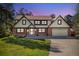 Traditional two-story home with a brick and siding exterior, well-manicured lawn, and attached garage at 8409 Lightening View Dr, Parker, CO 80134