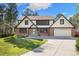 Charming two-story home with brick and vinyl siding, attached garage, and a well-manicured lawn at 8409 Lightening View Dr, Parker, CO 80134