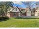 Two-story home with brick and vinyl siding, attached garage, and a lush green lawn at 8409 Lightening View Dr, Parker, CO 80134