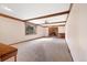 Cozy living room with a brick fireplace, wood beam ceilings, and large window at 8409 Lightening View Dr, Parker, CO 80134