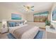 Bedroom featuring a queen sized bed, ceiling fan, and a large window at 8409 Lightening View Dr, Parker, CO 80134