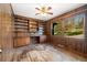 Office space with wood paneling, built-in bookshelves, and natural light at 8409 Lightening View Dr, Parker, CO 80134