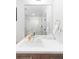 Bright bathroom featuring a modern sink, large mirror, and glass-enclosed shower with sleek fixtures at 2880 Zuni St # 309, Denver, CO 80211