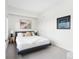 Calm bedroom featuring neutral decor, art, bedside lamps, and plush bedding at 2880 Zuni St # 309, Denver, CO 80211