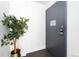 Hallway featuring wood floors, neutral colored walls, and a sleek modern entrance door at 2880 Zuni St # 309, Denver, CO 80211